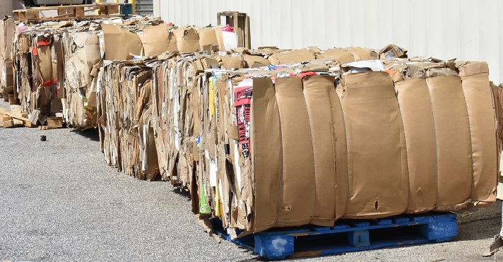 Large bundles of compressed cardboard await pickup. Many recycled materials in the United States are exported to China and other countries to be made into other products. Photo credit: Shutterstock.com. Cardboard recycling South Carolina, United States.