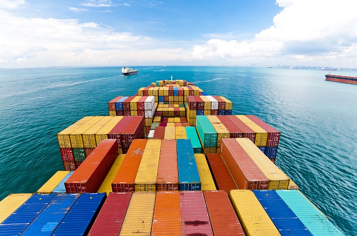A container ship heads out to sea. (Photo credit: Shutterstock.) A container ship heads out to sea.