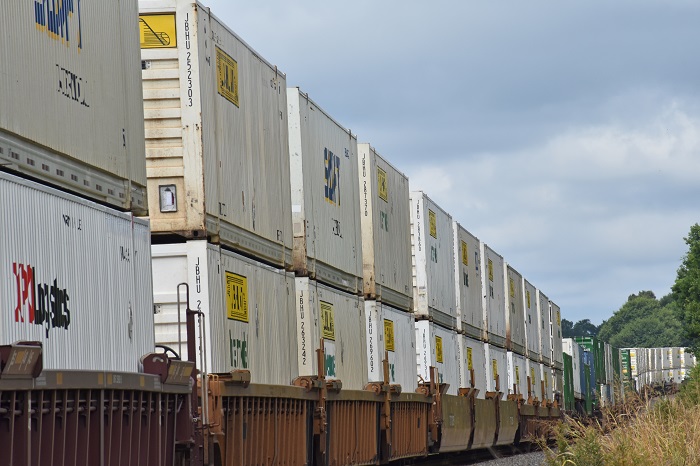 Tariffs on containers are unwarranted and will needlessly raise costs throughout the supply chain, business leaders testifying on Capitol Hill agreed. (Above: Containers being transported in the United States.) Photo credit: Shutterstock.com. Intermodal containers on a train in the US.