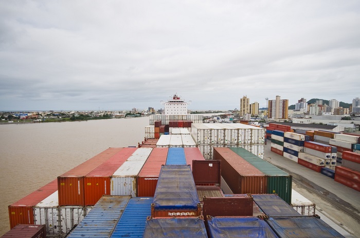 Decades of truck-oriented Brasilia administrations and a bias against rail created a vulnerable trade transport system. The spring truckers’ strike exposed it, and months later trade logistics has yet to recover. (Above: A container ship at the Port of Itajai, Brazil.) Photo credit: Shutterstock.com. Port of Itajai, Brazil.