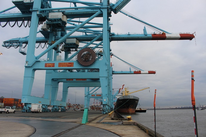 While terminals have made good strides in improving technology within the their four walls, they are poorly connected with the greater supply chain in which they play a critical role as the interface between the water and the land; that connectivity has to occur, for the industry to advance. And with ILA and ILWU labor peace, there’s now time to do it. (Above: Cranes at a terminal attend to a ship at the Port of New York and New Jersey.) Photo credit: Hugh R. Morley. Port of New York and New Jersey.
