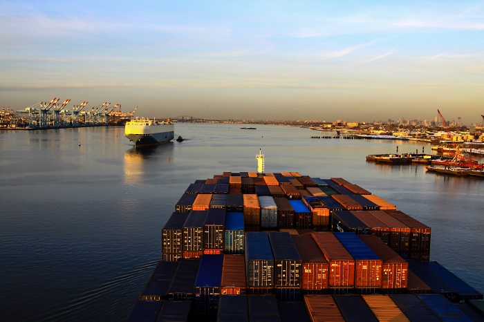 Although trade tensions between the US and the EU and their impact have been muted so far in 2018, as trade stakeholders know that could change dramatically, and quickly. (Above: A container ship approaches the Port of New York and New Jersey as another ship leaves.) Photo credit: Shutterstock.com. Port of New York and New Jersey container ship.