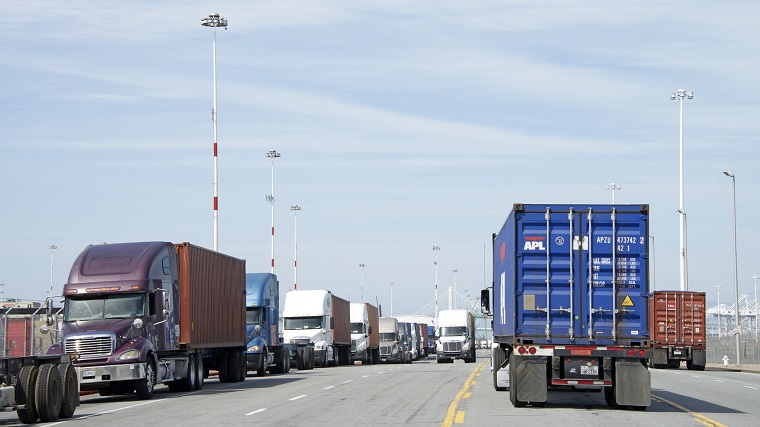 Demand for drayage has spiked in the last 7 to 14 days, but no one knows exactly why BCOs, NVOCCs, and freight forwarders are so hungry for truck power. (Above: Trucks line up for cargo at the Port of Oakland.) Photo credit: Shutterstock.com. Port of Oakland.