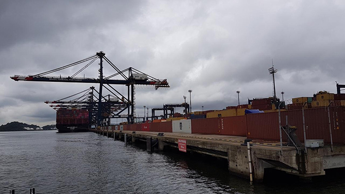 Terminal operators at Santos, Brazil's busiest container port, have built a wall out of empty containers in an effort to keep striking dockworkers from invading vessels. Photo credit: Sopesp.