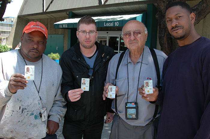 Dockworkers pose with their Transportation Worker Identification Credentials, which were mandated by Congress in the aftermath of the Sept. 11 terror attacks.