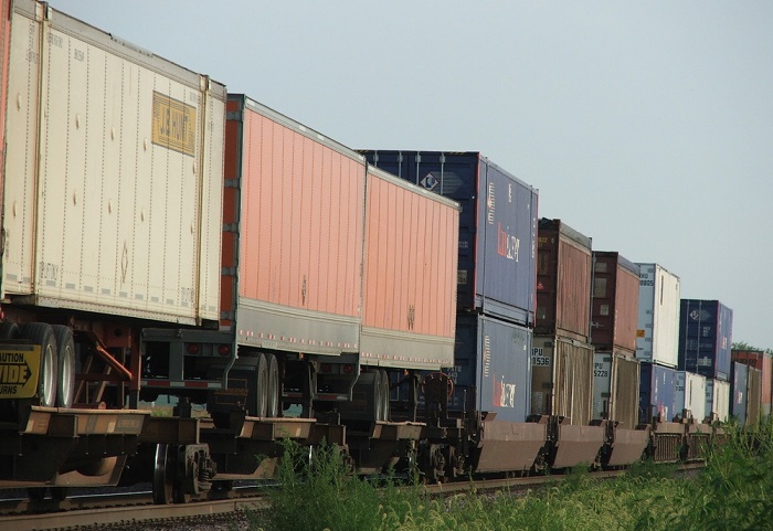 railroads supported trailers as a gateway to full domestic containerization, and as long as UPS relied on trailers, there was sufficient network density for trailers. Photo credit: Shutterstock.com. A double-stack train with truck trailers travels in the United States.