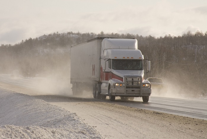 Truck drivers across North America have seen wages rise, sometimes more than once in 2018, according to the National Transportation Institute in the US. (Above: a truck travels in Canada.) Photo credit: Shutterstock.com. A truck travels in Canada.