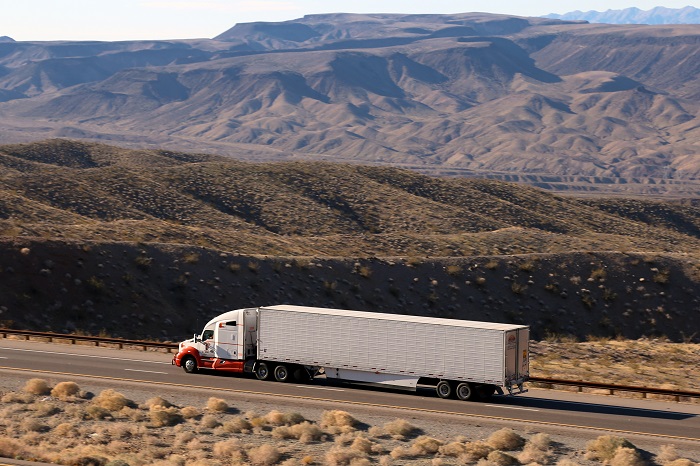 US trucking firms Swift, Knight, and Schneider report contract rate increases reaching into double digits, as do US truck shippers. Photo credit: Shutterstock.com. A truck travels in Arizona, United States.