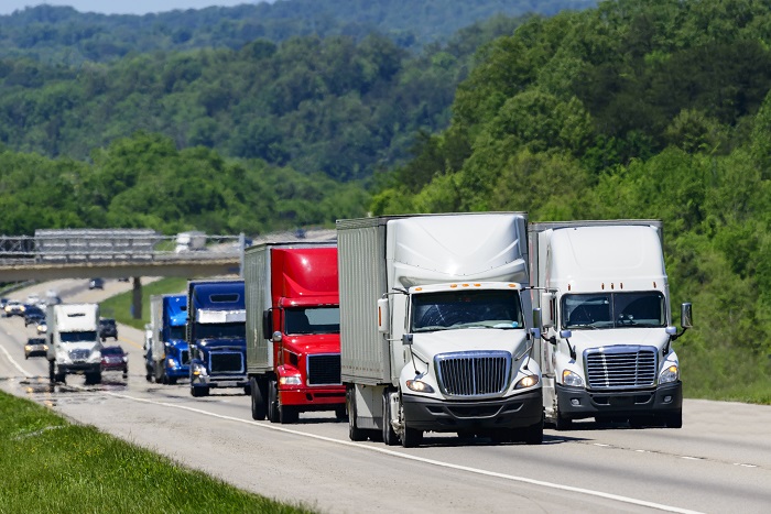 “There is no doubt transportation costs are rising — we’re at an inflection point,” Frank McGuigan, CEO of Transplace, told shippers. Photo credit: Shutterstock.com. Trucks travel on a highway in Tennessee, United States.