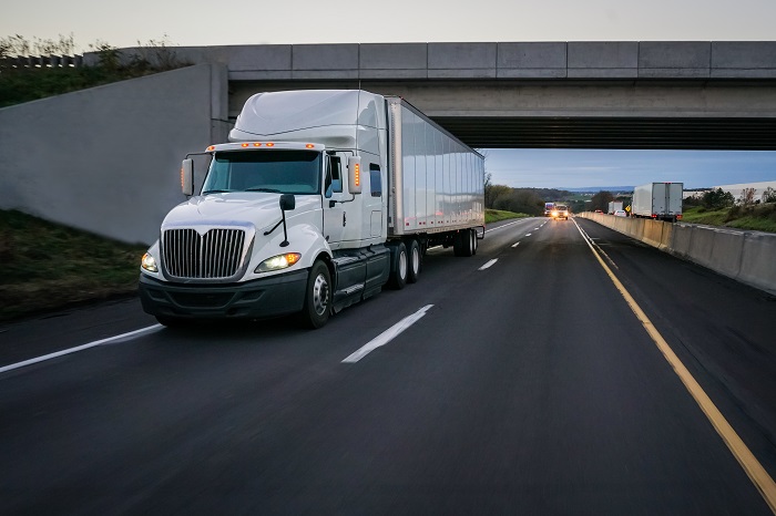 Above: A truck travels on a US highway. Photo credit: Shutterstock.com. A truck travels on a US highway.