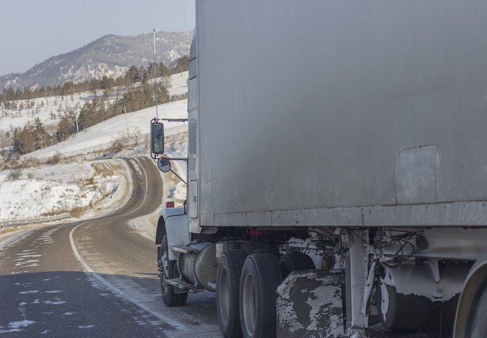 Despite a big surge in net truck orders, shippers shouldn’t expect near-term relief from the US truck capacity crunch. Registration numbers have also increased, but haven’t erased shortages. Photo credit: Shutterstock. A truck travels on a US highway.
