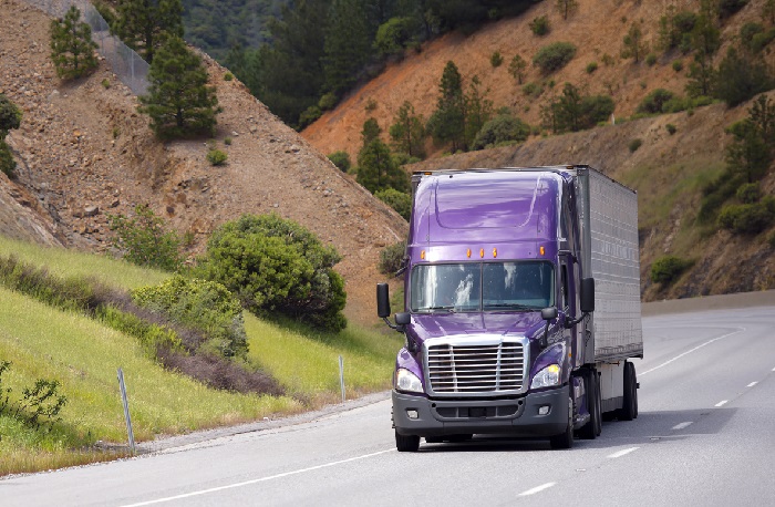 Shippers struggling to find a truck in the United States are turning to dedicated contract carriage. However, it’s not a simple switch and shippers are advised to do their homework — there’s an upside and a downside. Photo credit: Shutterstock.com. A truck travels on a US road.