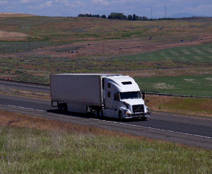 Logistics executives came to the Transpac Shipper Symposium this week hungry for solutions to what seem to be intractable problems of tight capacity and rising prices. And they received more than a few from Transplace CEO Frank McGuigan. Photo credit: Shutterstock.com. A truck travels on a US road.