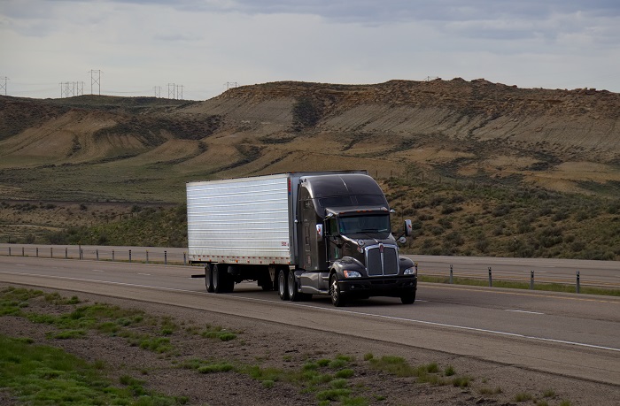 The answer for many US trucking executives is to create vocational apprenticeship programs of one type or another that would train 18- to 21-year-olds to drive heavy trucks. Photo credit: Shutterstock.com. A truck travels in Wyoming, United States.