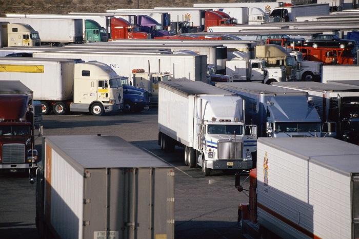 A coalition of trade groups wants Congress to advance a controversial plan that would get younger truck drivers on the road. (Above: A truck stop in California, United States.) Photo credit: Shutterstock.com. California US truck stop.