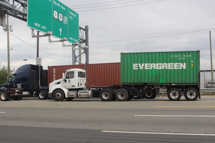 Shippers that send cargo through the Port of New York and New Jersey may want to monitor the outcome of the debate over how a truck driver is defined — as an independent contractor or employee — to determine whether a trucking group is correct that a change in the regulations could diminish the drayage service at the port. (Above: Trucks near the Port of New York and New Jersey.) Photo credit: Hugh R. Morley. Trucks near the Port of New York and New Jersey.