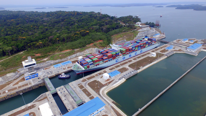 A Cosco Shipping vessel is towed through the new locks of the Panama Canal.