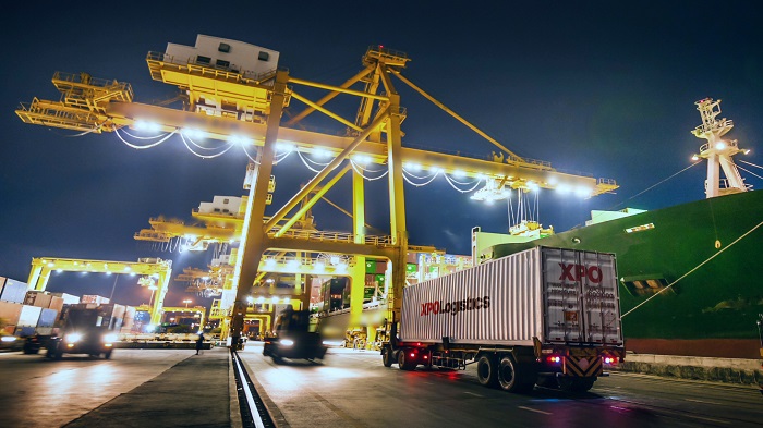 The digital platform will give customers of XPO’s non-asset brokerage and asset-based transportation services visibility into where their shipments are, their estimated time of arrival, and other business intelligence. Photo credit: Shutterstock.com. XPO Logistics truck arrives at a port.