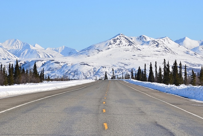 Rural highways in Alaska, like the one pictured, along with bridges and ports are among the beneficiaries of the .5 billion in discretionary grants announced Tuesday by the US Department of Transportation. Photo credit: Shutterstock.com. A highway in Alaska.