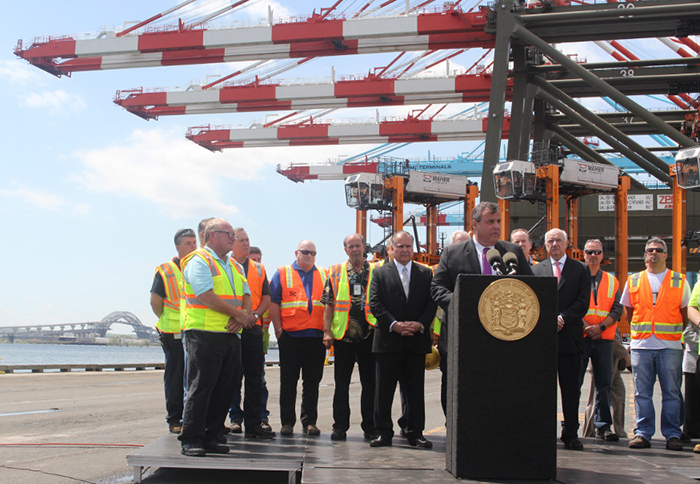 Governor Christie announces the opening of the renovated Bayonne Bridge will take place on June 30 at the Maher Terminals in Elizabeth, NJ, with the bridge in the background.