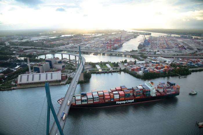 Hapag-Lloyd's 8,750 TEU Chicago Express sails beneath Hamburg’s Kohlbrand Bridge. The carrier posted an improved operating result in 2018. Photo credit: Hapag-Lloyd