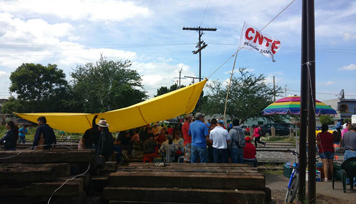 Members of the Coordinadora Nacional de Trabajadores de la Educación teachers' union blockade traintracks in Mexico's Michoacan state.