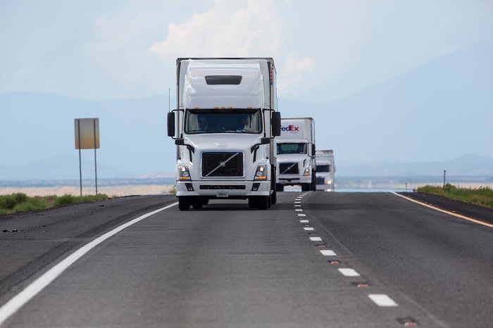 Trucks travel on a US highway.