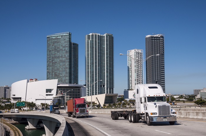 The national average dry van rate jumped 6 cents to $2.20 per mile, while the average refrigerated truck rate rose 8 cents to $2.57 per mile, DAT Solutions said Tuesday. (Above: Trucks travel in Miami, Florida, United States.) Photo credit: Shutterstock.com. Trucks traveling in Florida.