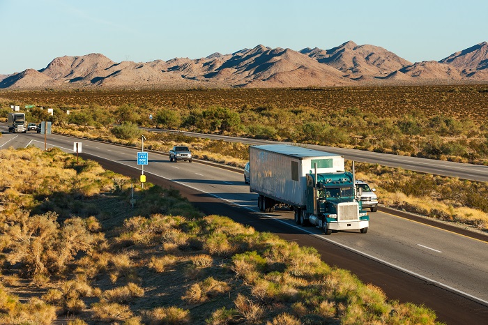 According to load board operator DAT Solutions, US spot truck freight volumes were down 30 percent year over year in September, compared to last year’s frenzied hurricane-related surge in spot shipments. Photo credit: Shutterstock.com. A truck travels in the United States.