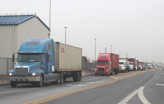 (Above: Trucks line up outside the Port of New York and New Jersey.) Photo credit: Hugh R. Morley. Trucks line up outside the Port of New York and New Jersey.
