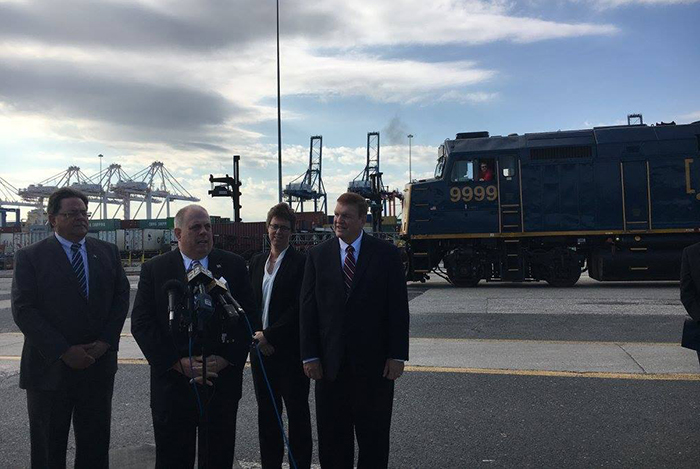 CSX Transportation Chairman and CEO Michael Ward, left, and Maryland Governor Larry Hogan, second from left, reaffirm their commitment to a tunnel project to allow double-stack freight trains to leave the Port of Baltimore.