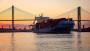 A container ship leaves the Port of Savannah at sunset.